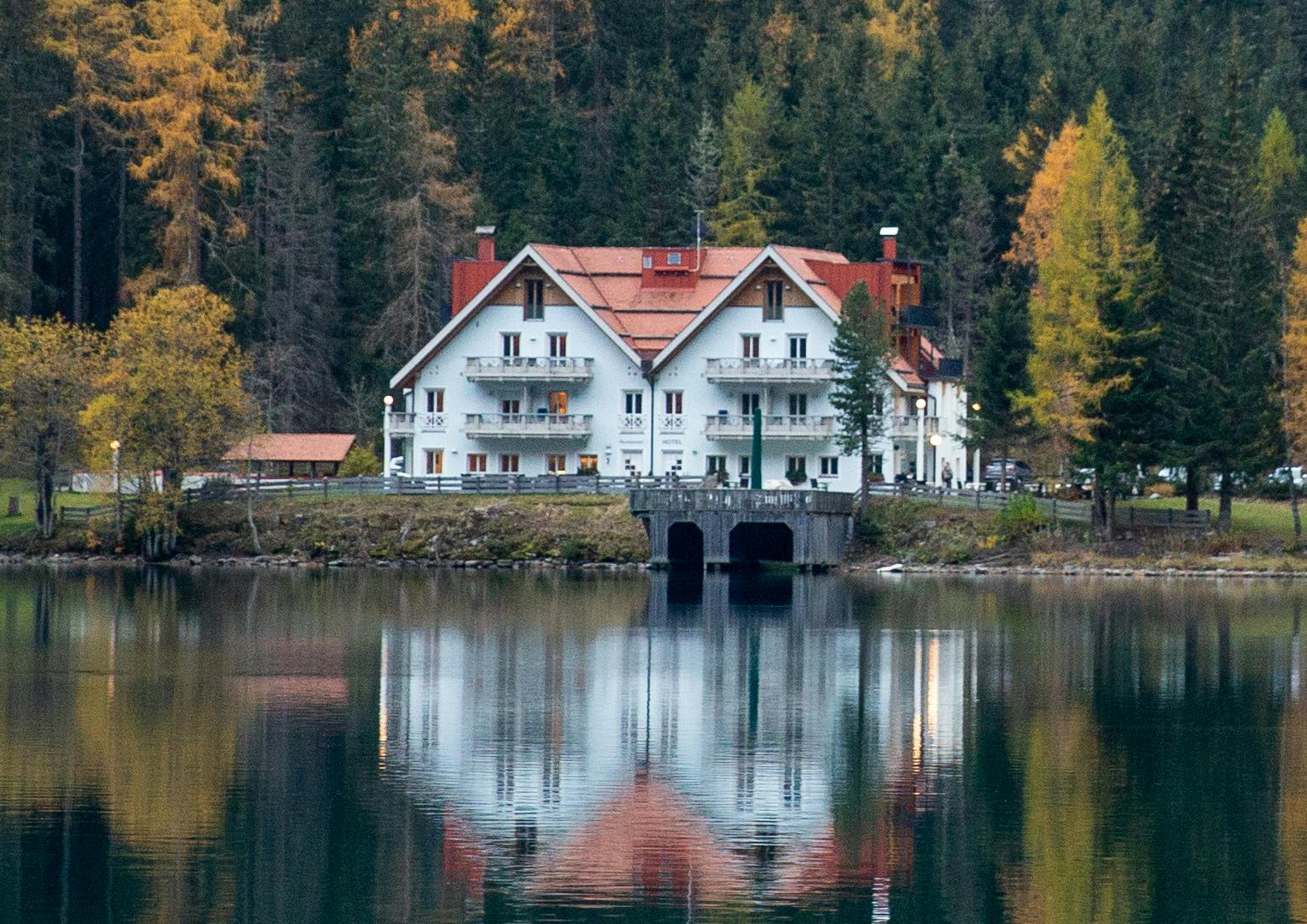A bright and reflective lake, surrounded by woods